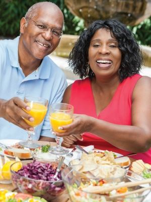 couple toasting with orange juice